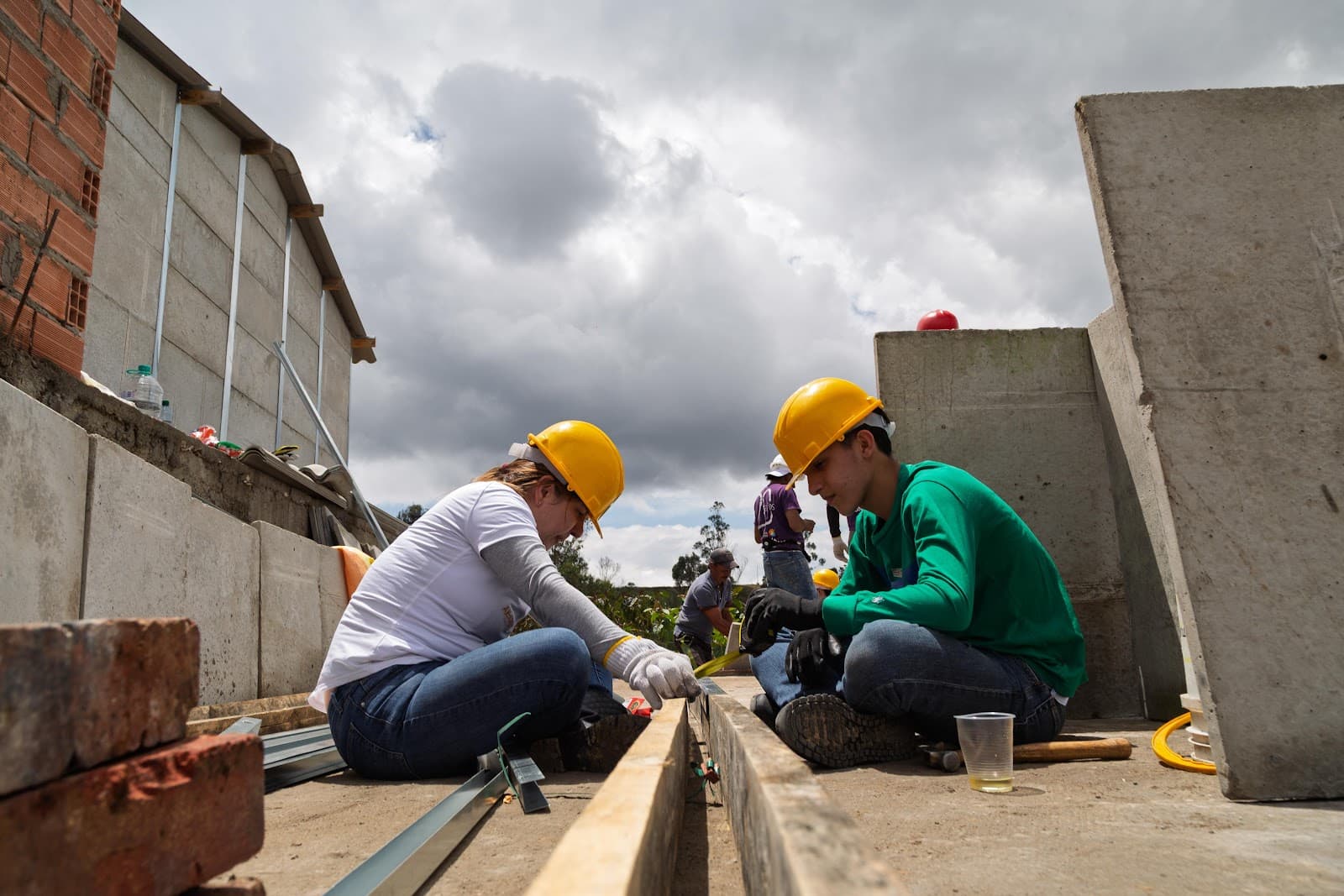 Volunteers working together on a structural beam